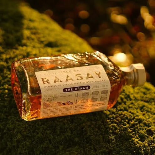 Bottle of raasay the dram whisky on moss